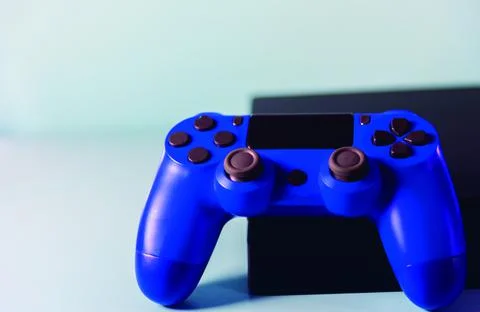Controls and video game console on light background Stock Photos
