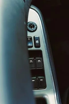 Controls for windows and locks in a car during daytime showing close-up vie.. Stock Photos