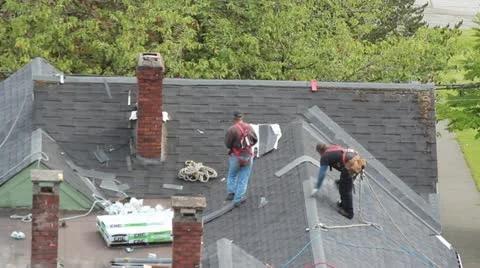 Contruction Workers (Residential) on House Roof Stock Footage