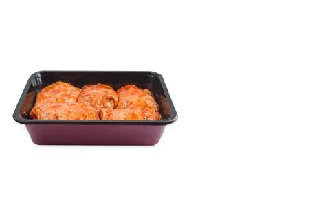 Convenience food,precooked.Marinated chicken thighs in tray for supermarket on Stock Photos