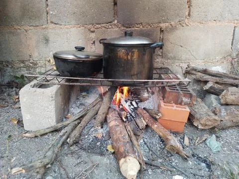 Conventional cooking stoves typically run on fuel such as wood charcoal, fi.. Stock Photos