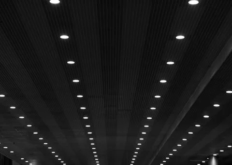 Converging lines of lights on a striped ceiling Stock Photos