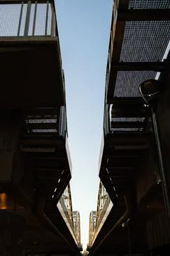 Converging lines of pedestrian bridge creating symmetrical composition against Stock-Fotos
