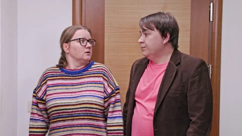 Conversation and reaction: two people engaging in discussion inside a modern Stock Footage 313460002