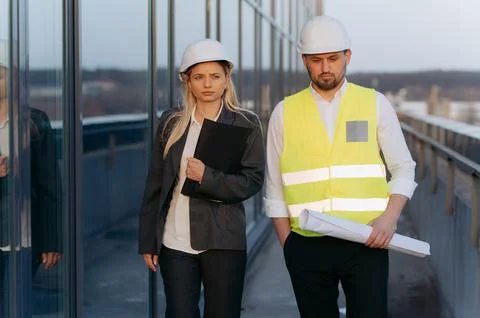 A conversation between two architect-engineers and an investor inspecting a b Stock Photos