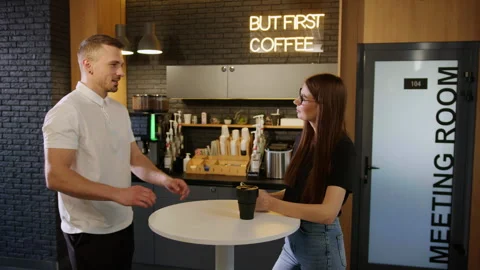 A conversation between two colleagues during a break in the office cafe Stock Footage 246053361