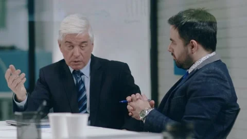 Conversation between two successful businessmen of different generations. The Stock Footage 147730097