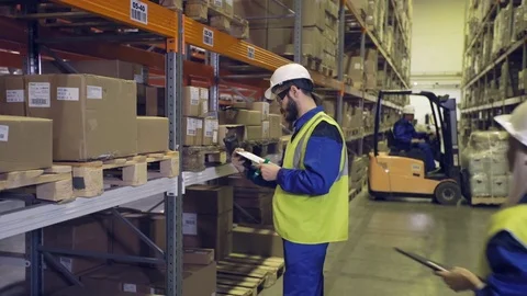 Conversation between warehouse workers Stock Footage 76002145