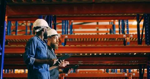 Conversation, tablet and walking with construction worker men in storage de.. 스톡 사진