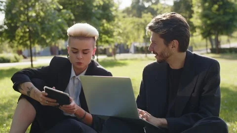 Conversation of two young business workers woman with guy using netbook and Stock Footage 251563125