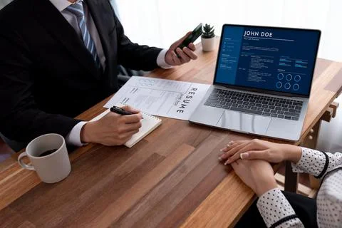 Conversational job interview between interviewer and candidate. Jubilant Stock Photos