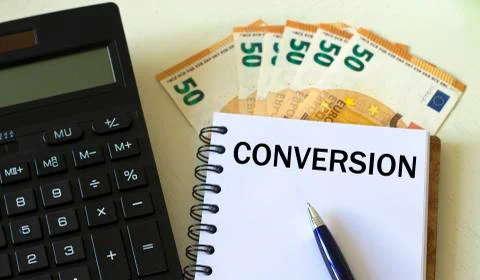 CONVERSION word in a notebook against the background of calculitar and bankno Stock Photos