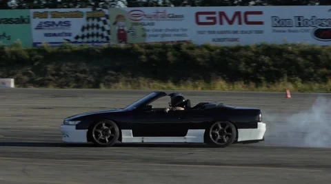Convertible car drifts around corner at drifting practice event. Stock Footage 59746911