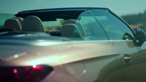 Convertible car moving on a highway, showcasing modern design and the lifestyle Stock Footage 339775884