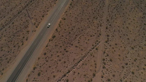 Convertible Driving Desert Road with Sun Reflection Stock Footage 327339819