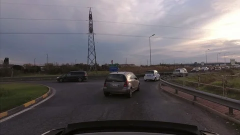 A convertible small car goes into the traffic at sunset Stock Footage 99296400