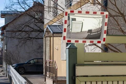 Convex traffic mirror for safe exit from residential driveway Stock Photos
