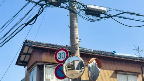 Convex Traffic Mirrors and Power Lines in a Kanazawa Neighborhood Stock Footage 331972446