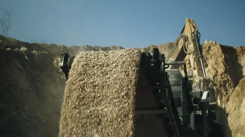 Conveying stone pieces, crushing machine and excavator at work in open pit Video stock 294074200
