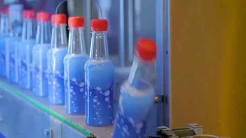 Conveyor belt of bottle labeling machine with empty plastic bottles Stock Footage 329945138