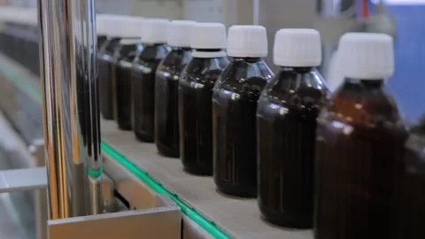Conveyor belt of bottle labeling machine with empty glass bottles - close up Stock Footage 341323165
