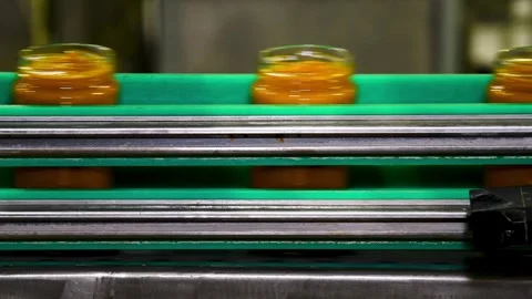 A conveyor belt with cans of mashed vegetables moving along it. Stock Footage 339913366