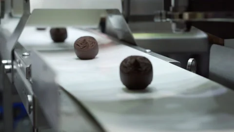 Conveyor belt with chocolates in close-up. Stock Footage 239632414
