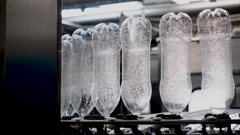 Conveyor belt with Empty bottles for drinking water at a modern beverage plant Stock-Footage 334588890