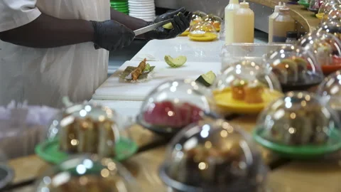 Conveyor Belt Plates While Worker Preps Roll at Sushi Restaurant Counter Stock Footage 340042735