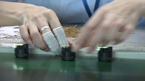 Conveyor belt, small audio components, electronics factory, hands, detail, China Stock Footage 60689172