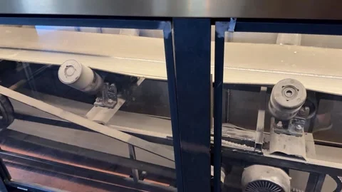 Conveyor belt transporting empty cardboard boxes in a packaging plant Stock Footage 314398368