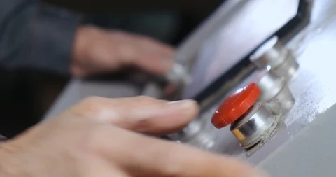 Conveyor control panel, factory worker presses red start button with his thumb Stock Footage 128786896