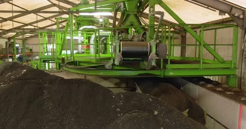 Conveyor Drum Above Rubber Granulate Heaps, Storage Bunker, High Angle Stock Footage 340661559