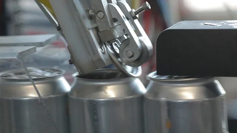 Conveyor for filling aluminum cans. Banks move along the conveyor and the Stock Footage