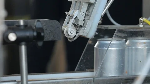 Conveyor for filling aluminum cans. Banks move along the conveyor and the Stock Footage