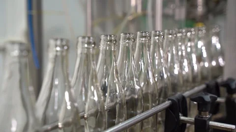 Conveyor line with moving empty clean transparent bottles. beverage production 動画素材 127309814