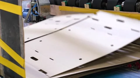 Conveyor line for the production of  boxes. Machine carves cardboard boxes from Stock Footage 140017107