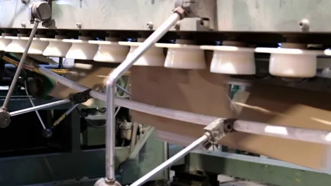 Conveyor line for the production of boxes. Machine carves cardboard boxes  Stock Footage 140547814