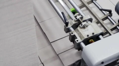 Conveyor line for the production of boxes. Machine cuts cardboard boxes from Stock Footage 150742991