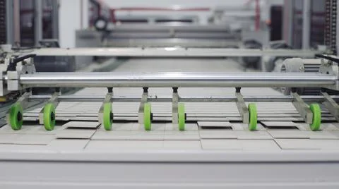 Conveyor line for the production of boxes. Machine carves and bends cardboard Stock Photos
