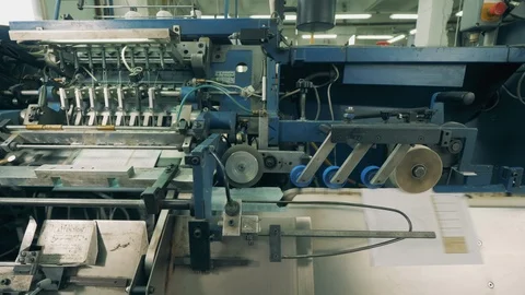 Conveyor machine is processing and cutting paper Stock Footage 127485095