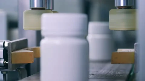 Conveyor machine is sealing small plastic tubs Stock Footage 154724455