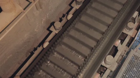 Conveyor  with ore shooting in  Close-up there is ore on belt conveyor 4K Stock Footage 235426742