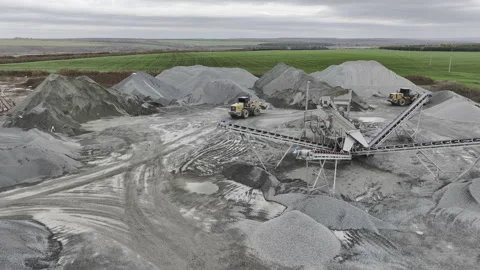 Conveyor system and driving backhoe at gravel mining quarry Video stock 237027210