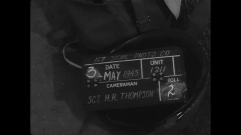 Convoy of German trucks, surrendering troops drive through town intersection Stock Footage 103378840