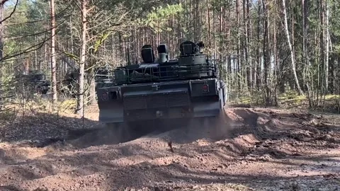 Convoy of main battle tanks travelling through woodland on earth track Stock Footage 267834553