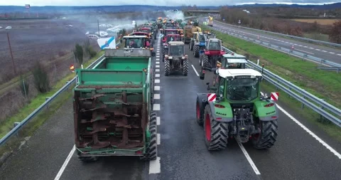 Convoy of tractors blocking a highway the concept of a farmers protest Stock Footage 326330641