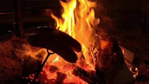 Coocking sausage over open fire Stock Footage 236203141