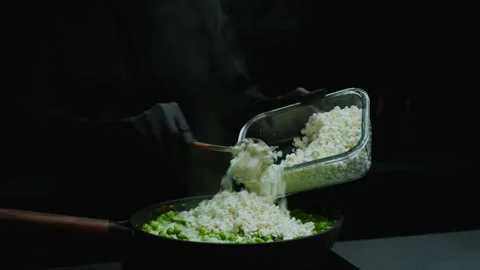 Cook adding cottage cheese to pan with peas Stock Footage 319745536