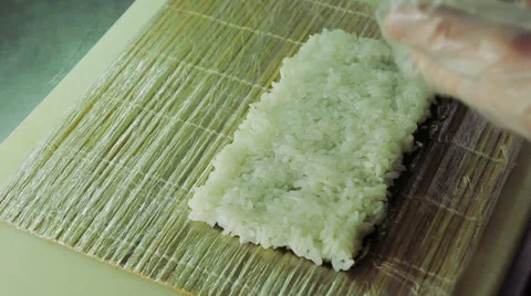 Cook adding green tobiko to sushi rolls Stock Footage 41963999